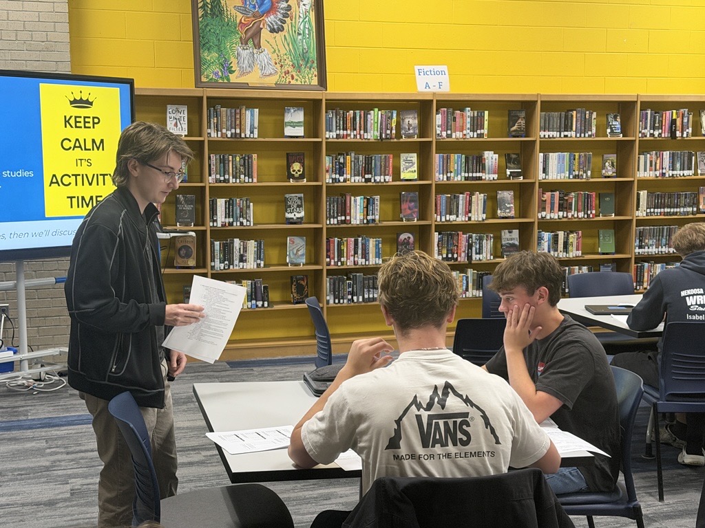 College for Rural Wisconsin Advisor meets with students in Nekoosa, WI in their school's library to talk about college applications. 